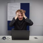 man grabbing head out of stress, looking for stress relief tips