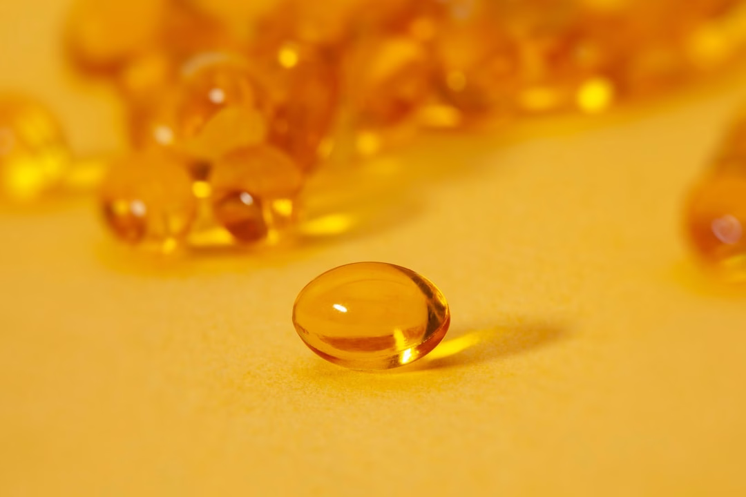 Vitamin D2 vs D3 comparison featuring orange softgel supplements