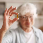 Senior woman taking an omega-3 fatty acids supplement