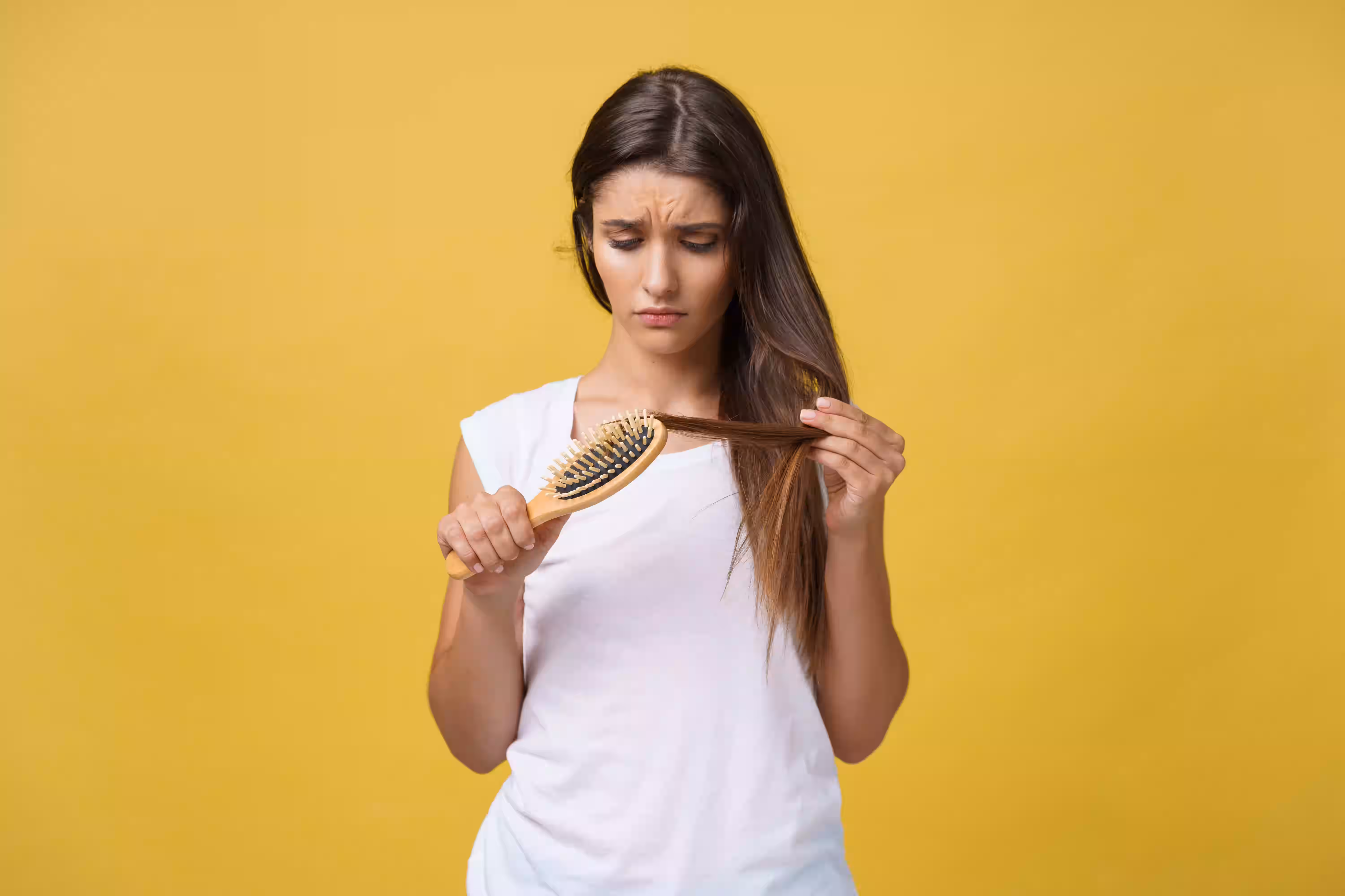 Woman experiencing possible zinc deficiency symptoms such as hair loss and skin changes